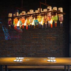 a wooden table topped with plates under a chandelier