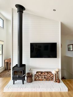 a living room with a fireplace and television mounted on the wall