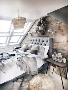 a bedroom with wooden walls and white bedding