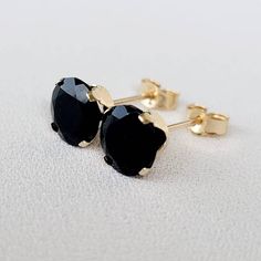 Embrace timeless sophistication with our genuine black onyx stud earrings. The deep, velvety black of onyx exudes a sense of mystery and elegance. Meticulously crafted for understated beauty, these studs add a touch of classic refinement to any ensemble. Elevate your style with the enduring charm of black onyx, a versatile and stylish addition to your jewelry collection. Two round genuine 6mm black onyx studs. These classic earrings are available in your choice of a 14K gold-filled setting, 14k Black Earrings With Prong Setting In Fine Jewelry, Black Prong Setting Earrings Fine Jewelry, Black Prong Set Fine Earrings, Fine Jewelry 14k Gold Black Earrings, Classic Black Spinel Jewelry, Black Pierced Earrings Fine Jewelry, Black Pierced Earrings In Fine Jewelry Style, Black Gemstone Earrings For Anniversary, Classic Onyx Earrings Gift