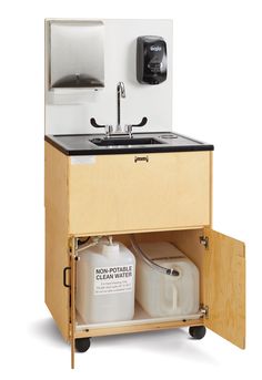 a sink with two containers underneath it and a water dispenser in the cabinet