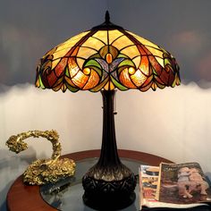 a lamp sitting on top of a table next to a magazine