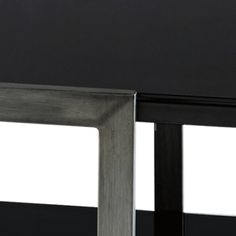 the back side of a black and silver table with two white squares on it's sides