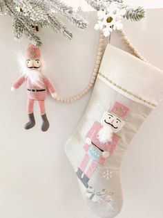 an ornament hanging from a christmas tree next to a stocking