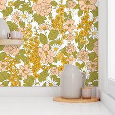 a kitchen counter with two vases on it and a flower wallpaper behind them