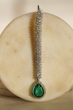 Enhance your elegance with the Safi Diamanté Accent Maang Tikka, a radiant piece crafted in a rhodium-plated silver finish. Available in stunning emerald green or sapphire blue, this exquisite maang tikka features a paved setting with glistening white diamante AD stones complemented by teardrop-shaped stones in your chosen hue. Its smaller size ensures a flattering fit for all face sizes, designed perfectly to complement our Sharmine necklace set. Key Features: Elegant Design: Paved setting with Accessories Ear, Ear Chain, Chandbali Earrings, Maang Tikka, Choker Necklace Set, Jhumka Earrings, Green Sapphire, Style Classique, Sapphire Blue