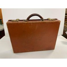 Vintage T. Anthony Leather Briefcase made in Englund. Classic attache for that working man or woman. Iconic simple design. Signed on it's hunter green interior. Perfect prop for that 1980's movie or that collector.  Dimensions: Height:12.75 in (32.39 cm) Width: 17 in (43.18 cm)Depth: 3.75 in (9.53 cm) Materials and Techniques: Leather Period: 1980-1989 Date of Manufacture: 1980-1989 Condition: Good, Wear consistent with age and use. Vintage Business Briefcase Rectangular Case, Vintage Rectangular Briefcase For Business, Vintage Rectangular Business Briefcase, Vintage Business Cases With Leather Lining, Vintage Rectangular Business Case, Vintage Rectangular Briefcase For Work, Vintage Rectangular Briefcase For Business Trips, Vintage Formal Briefcase With Luggage Sleeve, Vintage Leather Business Cases