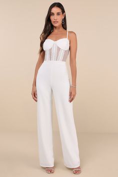 The Lulus Perfectly Sultry White Sheer Mesh Bustier Wide-Leg Jumpsuit is ready to help you create a look that is flawlessly flirty! This alluring jumpsuit starts with sheer mesh fabric that shapes a sweetheart neckline and a bustier-inspired bodice with padded cups, corset-style seams, and floral lace accents throughout, all supported by adjustable spaghetti straps. The high, banded waist tops wide pant legs (composed of stretchy crepe knit) that fall to ankle-length hems. Hidden back zipper/clasp. Fit: This garment fits true to size. Length: Floor length. Size medium measures 53" from adjustable straps to hem. Bust: Great for any cup size. Waist: Fitted - very fitted at natural waist. Hip: Fitted - stretchy fabric allows room for hips. Undergarments: Padded cups - May be worn with petals, Bridal Wardrobe, Mesh Jumpsuit, Sheer Clothing, Reception Dress, Wide Pants, Corset Style, Wide Leg Jumpsuit, Mesh Fabric, Sweetheart Neckline