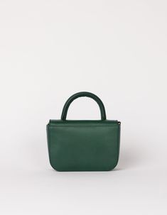 Our ever-popular mini bag, the Nano in a classic autumnal hue: Pine Green, for our FW24 collection. One of the smallest and most compact bags in our collection: The Nano Bag. This itty-bitty bag is all about the essentials. With enough space for your mobile phone, coin purse, lip balm and keys, the little Nano Bag makes a big statement. Featuring an inside zip pocket for extra security and a slip-in pocket for easy access. Her front flap closes with an inner magnet and her strap has a knob-button system to adjust the length. OMB-E137PGV Small Elegant Shoulder Bag With Dust Bag, Small Elegant Shoulder Bag, Small Elegant Travel Bag, Luxury Small Bags For Everyday Use, Luxury Small Bag For Everyday Use, Green Flap Bag With Dust Bag For Daily Use, Classic Green Bag With Detachable Handle, Small Elegant Bag For Everyday Use, Elegant Small Bag For Everyday Use