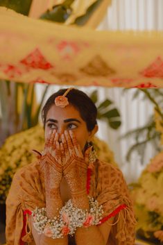 a woman with her hands covering her face