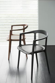 two chairs sitting next to each other on top of a wooden floor