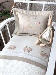 a stuffed animal sitting on top of a white chair next to a pillow with the word love