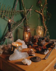 a table topped with lots of different types of candles and other things on top of it