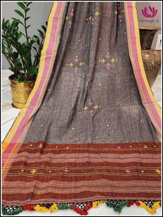 Look stylish and breezy in this summer boho style dupatta. Crafted from handloom Kala cotton for an extra soft feel, the dupatta features Gray body with embroidery and small mirror work. Brick color on both sides, giving it an extra touch of visual charm. The dupatta is finished with beautiful tassels for an elegant look. Please note: Color may vary slightly from the picture. Thread pulls, knots and few thread gaps are common in this type of dupattas and is not a defect. Very minor stains from t Cotton Dupatta With Mirror Work, Festive Cotton Dupatta With Motifs, Multicolor Cotton Dupatta With Woven Motifs, Cotton Dupatta With Motifs In Traditional Drape, Cotton Dupatta With Traditional Motifs, Bollywood Cotton Dupatta With Motifs, Festive Mulmul Dupatta With Embroidered Border, Bollywood Style Cotton Dupatta With Motifs, Bollywood Style Embroidered Mulmul Dupatta