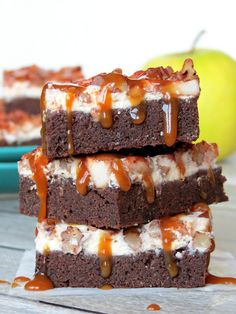 three brownies stacked on top of each other with caramel drizzle