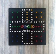 a family game night sign on a wooden wall with polka dot dots and the words family game night written in large letters