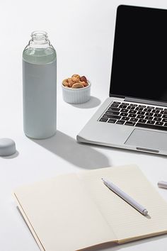 an open laptop computer sitting on top of a white desk