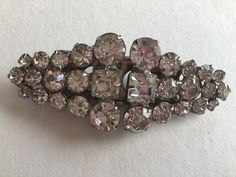 Vintage Dress Clip/Brooch.Silver tone, rhinestones Austria Crystal.Excellent quality.New.Newer worn.Unmarked Coro. Excellent vintage condition. Vintage Rhinestone Brooches For Vintage Events, Vintage Rhinestone Brooches For Party, Vintage Rhinestone Party Brooches, Vintage Rhinestone Brooches For Evening, Vintage Evening Brooches With Rhinestones, Retro Wedding Brooches With Rhinestones, Vintage Sparkling Brooches For Party, Vintage Sparkling Brooches For Formal Wear, Vintage Sparkling Brooches For Formal Occasions