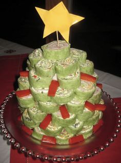 a cake made to look like a christmas tree with candy wrapped around it and a star on top