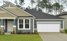 a gray and white house with two garages