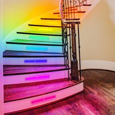 the stairs are painted with different colors and numbers on them, as well as an illuminated clock