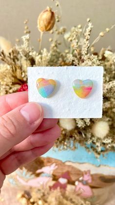 Pastel rainbow heart polymer clay stud earrings  These earrings are uniquely handmade by me using polymer clay. Each pair are carefully crafted to be extremely lightweight, durable and guarantee to add the perfect statement to your look!  Please note that due to the handmade nature of these items, some slight differences or imperfections may occur. Made with hypoallergenic earrings hooks or posts. This listing is for 1 pair of earrings. JEWELRY CARE: Store your jewelry in a clean, dry place. Avo Hand Painted Multicolor Heart Earrings For Gift, Hand Painted Multicolor Heart Earrings As Gift, Rainbow Heart Earrings For Gift, Rainbow Heart Earrings As Gift, Colorful Polymer Clay Earrings As Gift, Handmade Multicolor Heart Earrings, Multicolor Heart-shaped Hand Painted Earrings, Hand Painted Multicolor Heart Earrings, Rainbow Heart Earrings For A Gift