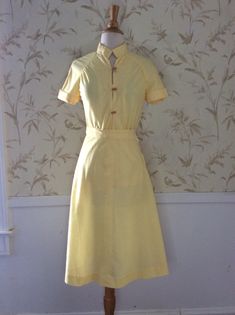 "Vintage Skirt Set 1950's Vintage Blouse and Skirt Handmade so One of a Kind It wasn't worn though. The button and buttonhole was never done Linen Look sheer Lemon Yellow Cotton Mandarin Style Blouse with Raglan Sleeves and gathering below the seam Wood Toggle buttons and loops Cuffed sleeves A Line Skirt with a size seam metal zipper No size tag, so Please go by measurements taken laid flat seam to seam 18\" armpit to armpit 25 1/2\" long 12 1/2\" waist skirt 20\" hips 25 1/2\" long Excellent V Spring Fitted Skirt Suit With Button Closure, Classic Spring Skirt Suit With Buttons, Fitted Vintage Fashion Skirt For Spring, Fitted Skirt For Spring Vintage Fashion, A-line Fitted Skirt With Buttons, Fitted A-line Skirt With Buttons, Spring Vintage Fashion Fitted Skirt, Summer Daywear Skirt With Buttons, Fitted Summer Skirt For Semi-formal Occasions