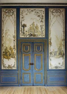 an empty room with blue doors and wallpaper on the walls is pictured in this image