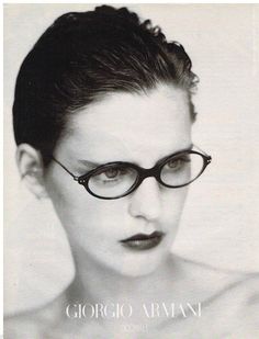 a black and white photo of a woman wearing glasses with the words george armani on it