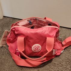 Brand New Never Used With Tag Barbie X Kipling Barbie Bina M Small Nylon Crossbody Handbag This Is A Beautiful Nylon Bag, Which Is Your Go-To Bag, Ready For Any Day, Any Weather. It's Lightweight, Durable, And Water-Resistant! Small Sized Bag; 10-3/4"W X 6-3/4"H X 5-1/2"D (Width Is Measured Across The Bottom Of Handbag); 0.68 Lbs. Approx. Weight Silhouette Is Based Off 5'9" Model 4"L Handles; 25"L Removable, Adjustable Strap Zippered Closure Silver-Tone Hardware & Barbie Keychain Interior Zip & Slip Pockets Nylon Nylon Satchel With Removable Pouch, Pink Nylon Mobile Phone Bag, Pink Nylon Bag With Detachable Strap, Pink Nylon Shoulder Bag With Detachable Strap, Functional Pink Mobile Phone Bag, Nylon Satchel Shoulder Bag With Mobile Phone Pocket, Nylon Satchel Shoulder Bag With Mobile Phone Holder, Nylon Satchel Shoulder Bag With Mobile Phone Bag, Nylon Crossbody Shopping Bag