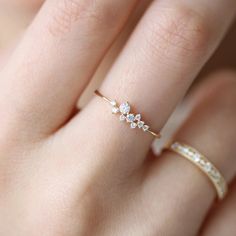 a woman's hand with a diamond ring on top of her finger and an image of