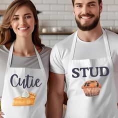 two people wearing aprons that say cutie and stud with blueberries on them