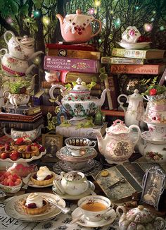 a table topped with lots of different types of tea pots and plates filled with food