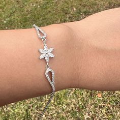 Daisy Diamond Flower Silver Charm Bracelet Anniversary Gift For Woman ⭐ All of our products are handmade and their materials are 925 sterling silver. ⭐ Bracelet lenght : 7.4'' (19 cm) ⭐ Bracelet weight : 3.69 gr ⭐ Materials: Silver ⭐ Nickel free hypoallergenic for sensitive skin. ⭐ Lightweight, perfect for everyday wear. ⭐ All of our products are handcrafted and ± 5% deviation may occur in grams and sizes. ⭐ If you have any question, contact us freely. ⭐ The light color of the photos may vary on computer and phone.      --- Care Guide --- * Unfortunately, 925 sterling and all other silver types tarnish in time. So the question is; How can we slow it down? * Contact with water: Not a great idea. But, it is unlikely to do any lasting damage. Just make sure to dry it after. * Swimming Pool: C Flower Shaped Crystal Bracelet Gift, Flower Shaped Cubic Zirconia Bracelets As Gift, Elegant Silver Bracelets With Flower Shape, Flower-shaped Cubic Zirconia Bracelets For Gifts, Flower-shaped Cubic Zirconia Bracelets As Gift, Elegant Silver Bracelets In Flower Shape, Flower-shaped Cubic Zirconia Bracelet For Gifting, Dainty Silver Flower Bracelets, Elegant Silver Flower Bracelets