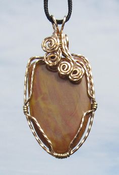 "This is a Pendant made from Scenic or  Picture Jasper. wrapped in Bronze wire. The stone has colors that give interest to the cabachon. the size of the pendant is 2  1/2 \" x 1 1/8\" it comes on a 30\" black cord, # 18-0623" Wire Wrapped Jasper Jewelry As Gift, Jasper Wire Wrapped Jewelry As Gift, Wire Wrapped Jasper Jewelry For Gifts, Gift Jasper Wire Wrapped Jewelry, Gold Freeform Wire-wrapped Jewelry, Hand Wrapped Wire Pendant Jewelry, Gold Wire Wrapped Freeform Jewelry, Gold Freeform Wire Wrapped Jewelry, Unique Brown Wire Wrapped Jewelry