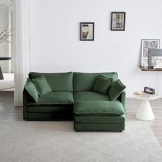 a green couch sitting on top of a white rug