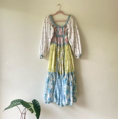 I love this unique 1970's Gunne Sax style dress that I picked up from a Los Angeles flea market years ago.  A lovely flower child spring/summer style that looks as if it could have been hand designed and made. Multi patchwork style floral fabrics, some of which are embroidered, and trimmed in light blue ribbon.  With a flattering fit, long billowy cotton sleeves and elastic detail across bust and ribcage area.  This cute bohemian dress can be worn off or on the shoulder.  Please see more details below.  Brand: Unknown - No Interior Label Size: No Size Indicated, Estimate This To Work Well For Size Small. Please See Measurements Below Condition: Excellent / Very Good Vintage Condition. I just had elastic replaced in the shoulders Color: White, Pink, Blue, Yellow Fabric: Cotton Embroidered Spring Long Sleeve Dresses For Gatherings, Spring Gatherings Long Sleeve Dresses, Long Sleeve Dresses For Spring Gatherings, Hippie Multicolor Dresses For Spring, Spring Hippie Multicolor Dresses, Spring Multicolor Hippie Dresses, Spring Long Sleeve Cottagecore Peasant Dress, Patchwork Dresses For Garden Party In Spring, Spring Cottagecore Long Sleeve Peasant Dress