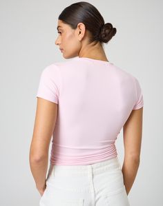 This jersey style t-shirt features supersoft material, short sleeves and a long line length. V-neck Athleisure Top, Athleisure Stretch T-shirt For Spring, Sporty Fitted Top T-shirt, Sporty Pink Jersey Top, Pink Short Sleeve Top In Elastane, Fitted Pink Short Sleeve T-shirt, Pink Fitted Top With Short Sleeves, Pink Short Sleeve Elastane Top, Pink Fitted Short Sleeve Top