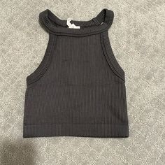 95% Nylon 5% Spandex Fitted Gray Tank Top For Spring, Chic Fitted Gray Crop Top, Trendy Fitted Gray Tank Top, Trendy Fitted Gray Crop Top, Chic Gray Stretch Crop Top, Gray Fitted Seamless Crop Top, Fitted Seamless Gray Crop Top, Gray Stretch Ribbed Crop Top, Fitted Gray Crop Top For Spring