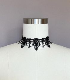 This black lace choker is a striking piece of jewelry that combines gothic elegance with boho style. Crafted from delicate black lace, it has a Victorian-inspired design, giving it a timeless and dramatic look. The lightweight textile choker sits comfortably around the neck, making it a perfect accessory for both casual and formal occasions. Whether you're looking for a statement piece or a subtle touch of vintage charm, this gothic lace necklace is an excellent choice. A wonderful gift for her, Black Lace Necklace, Gothic Choker, Gothic Elegance, Gothic Lace, Black Lace Choker, Gothic Chokers, Lace Choker, Lace Necklace, Victorian Lace