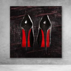 a pair of black and red high heeled shoes on a dark background with the word,