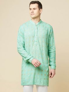 This Mint Green Lucknowi Embroidered kurta will instantly give an elegant look. Made from polyester cotton fabric, this 2 piece kurta set features a mint green lucknowi kurta, front buttons fastening, designer cuff buttons, and a mandarin collar. This mint green kurta has beautiful sequins Jaal thread embroidery work all over. It is paired with white churidar pants. An ideal outfit for traditional & special events.

Size Chart For Men





	
	
					Men's Size Chart
		

		
		
						
				Size Char Lucknowi Kurta, White Churidar, Rohit Bal, Thread Embroidery, Churidar, Kurta Set, Embroidery Work, Modern Bride, Green Cotton