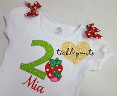 --♥♥-- Your birthday top will be embroidered with Birthday Girl's age in green (fabric will vary) and with two little strawberries. Name will be red and matching bows will be sewn to the shoulders. SIZING: Bodysuits are Carter's brand and smaller and are available in sizes 3m, 6m, 9m, 12m, 18m, 24m. Shirts are specific for embroidery and run true to size. Available sizes 2T, 3T, 4T, 5, 6 and 8. There is no size 7. CARE INSTRUCTIONS: Please handwash cold and flat dry, do not machine wash or dry. Fitted Red Top For Birthday, Red Fitted Top For Birthday, Cute Red Tops For First Birthday, Cute Red Top For First Birthday, Green Short Sleeve Top For First Birthday, Cute Red Top For Birthday, Green Casual Top For First Birthday, Green Spring Birthday Top, Cute Green Tops For Gifts