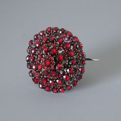 Stunningly beautiful antique red Bohemian garnet pin brooch. Authentic Victorian piece of jewelry from circa 1880's. Over 140 sparkling faceted red garnets are set in 4 consecutive tiers. The gold tone metal setting is a tombak alloy (also known as pinchbeck), which was very popular in the 19-th century. All photos were taken at daylight, the first 2 photos were taken at sunlight, so you can see how the the garnets are sparkling. The brooch will be shipped in a gift box. Garnet is known as the b Antique Red Brooch Jewelry, Antique Red Brooch, Antique Red Brooch For Formal Occasions, Antique Red Wedding Brooch, Garnet Jewelry Set, Natural Bohemian, Garnet Bracelet, Garnet Necklace, Garnet Jewelry