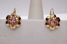 These are so cute! This is a pair of flower design earrings that have 5 mm round synthetic pink stones in the center. The stones are single cut. The earrings have lever backs so there are no backs to lose :) The back of the earrings are stamped 14K Italy and they weigh 3.4 grams. *We are always willing to ship Internationally! Please message us for a quote!* Pink Flower Shaped Pierced Earrings, Pink Earrings With Lever Back For Anniversary, Pink Lever Back Earrings For Anniversary, Formal Pink Round Flower Earrings, Formal Pink Flower Earrings, Pink Round Flower Earrings For Anniversary, Pink Flower Earrings For Anniversary, Puzzle Ring, Pink Stones