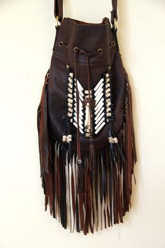 Medium fringed leather bag, antique brown color, boho style Handcrafted bone bead and natural coconut bead embellishment choker attached as decoration Fully lined inside with one pocket. The adjustable leather shoulder strap fits either across the body or slung over your shoulder. Material: leather, cow bones,coconut bead, turquoise crystal bead 8.2 in wide, 11.4 in long. total long include feather fringes 18.9 in aprox 21 cm wide,29 cm long. total long include leather fringes 48 cm aprox Best f Bohemian Bags With Beaded Fringe For Everyday Use, Bohemian Festival Bags With Beaded Fringe, Bohemian Brown Bag With Beaded Fringe, Brown Hippie Shoulder Bag With Adjustable Strap, Bohemian Fringe Hobo Shoulder Bag, Hippie Brown Shoulder Bag, Festival Leather Bag With Tassels, Leather Fringe Hobo Bag For Festivals, Bohemian Brown Hobo Bag