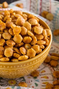 a yellow bowl filled with nuts on top of a table