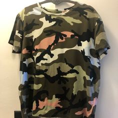 Valentino Camouflage T-Shirt Size S In Great Condition, No Damage In A Smoke-Free Home & No Smell. Has Gold Rock Stud On Top Back (Shown In Pics). Runs Small. Camouflage Graphic Print Crew Neck T-shirt, Khaki Crew Neck Tops With Graphic Print, Casual Camouflage Short Sleeve T-shirt, Camouflage All-over Print Cotton Tops, Camouflage All Over Print Cotton Tops, Khaki Graphic Print Short Sleeve Tops, Summer Camouflage Cotton T-shirt, Green Military Style T-shirt With Crew Neck, Military Crew Neck T-shirt For Streetwear