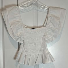 Nwt Zara Flutter Ruffle Shoulder Sleeveless Smocked Bodice Top White M 3253 807 250 Layered Ruffle Shoulder Elastic Smocked Knit Bodice Ruffle Hem Measures: Chest - 12" Across Length - 20" Shoulder To Hem Offers Welcome! White Ruffled Smocked Top For Summer, Summer Smocked Top With Ruffles For Day Out, White Top With Ruffled Hem And Straps, Day Out Sleeveless Smocked Top With Ruffle Hem, Spring Smocked Top With Ruffled Straps And Details, White Sleeveless Smocked Top For Brunch, White Tops With Ruffled Straps And Details, Stretch Top With Ruffled Straps And Details, Spring Smocked Top With Ruffles And Ruffled Straps