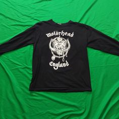 "Motorhead Classic \"Snaggle Tooth - Motorhead England\" Black Longsleeve T-Shirt.  A variation on the black t-shirt classic.  These were sold at the shows in 2000.  The back features the classic \"Everything Louder Than Everything Else\" Slogan.  This shirt is brand new and has never been worn." Punk Black T-shirt For Biker Events, Black Biker Top With Skull Print, Biker T-shirt With Skull Print In Cotton, Biker T-shirt With Skull Print, Black Punk T-shirt For Biker Events, Skull Print Crew Neck T-shirt For Biker Events, Biker Style Cotton T-shirt With Skull Print, Punk Style Black T-shirt For Biker Events, Grunge Crew Neck Tops For Biker Events